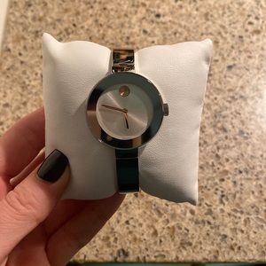 Selling silver Movado bold watch with rose gold accents.